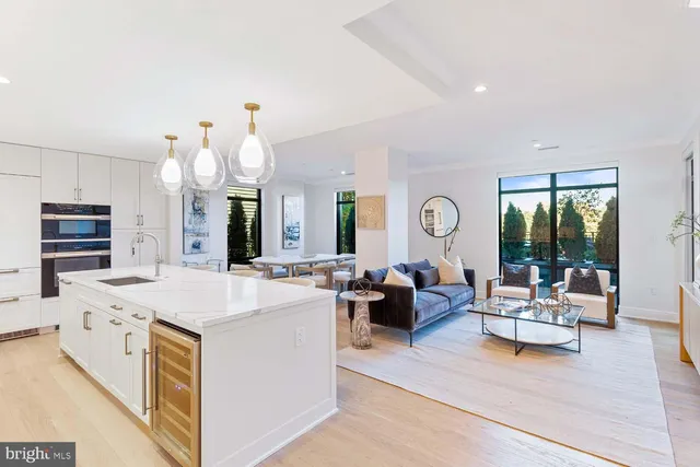 a living room with fireplace furniture and a large window