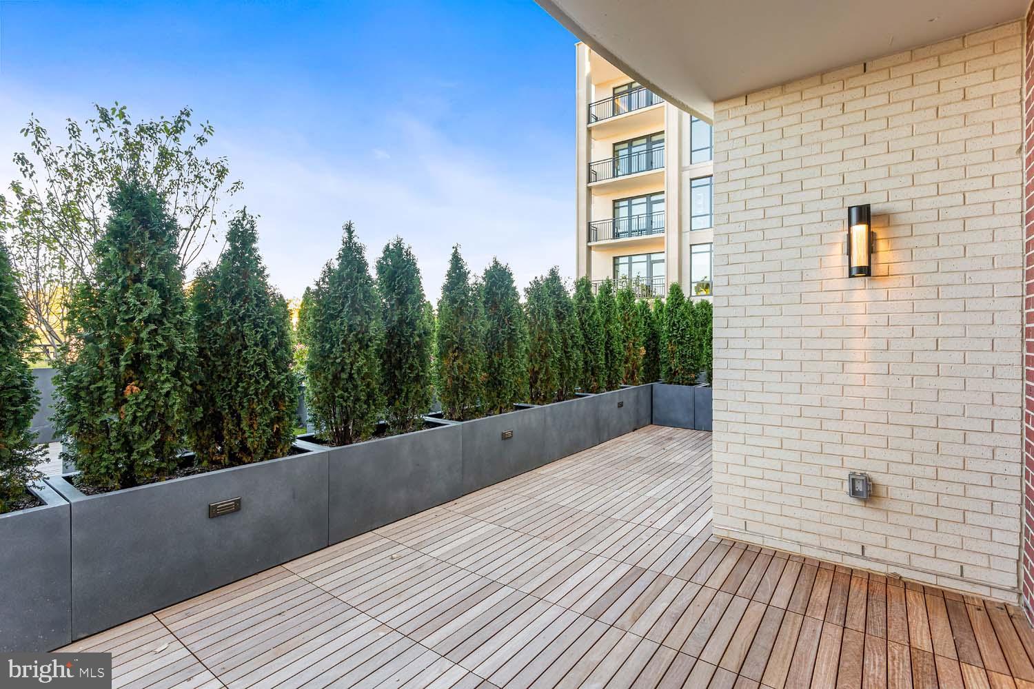 6718 Lowell Avenue, Unit 406 McLean, VA 22101 - Photo 42 of 86 a view of balcony with wooden floor and fence