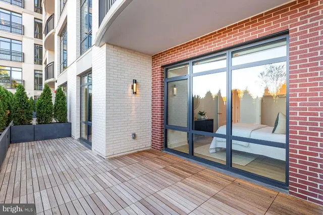 a view of a patio with a table and chairs and potted plants