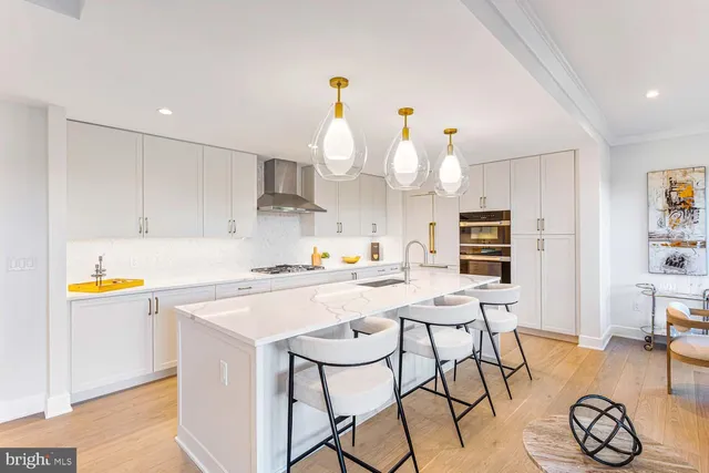 a kitchen with a refrigerator and a stove