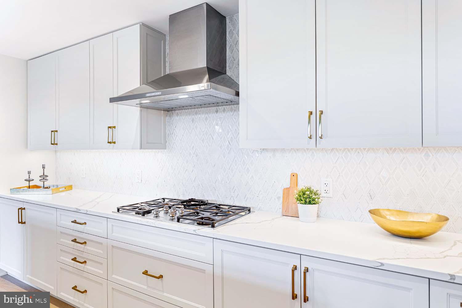 6718 Lowell Avenue, Unit 406 McLean, VA 22101 - Photo 9 of 86 a kitchen with a sink a stove and cabinets