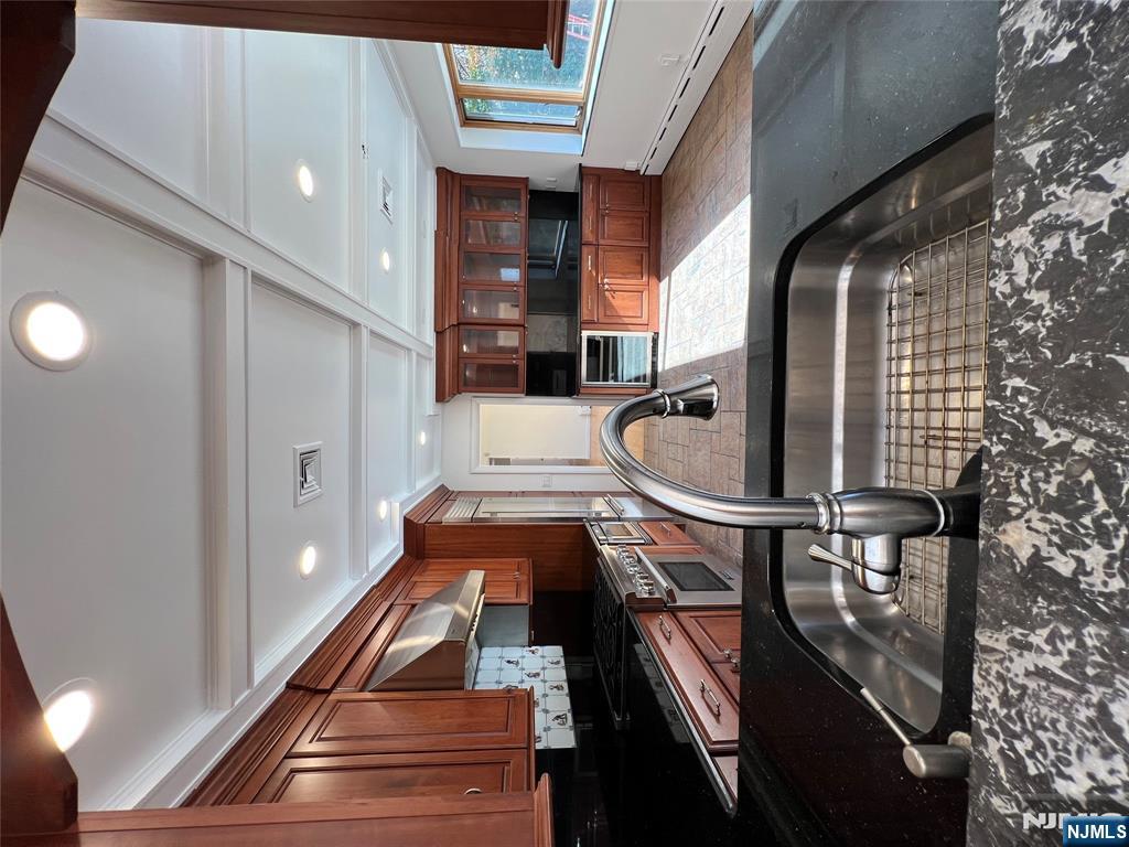 391 Forest Road Mahwah, NJ 07430 - Photo 11 of 32 a kitchen with stainless steel appliances granite countertop a sink a stove counter space and cabinets