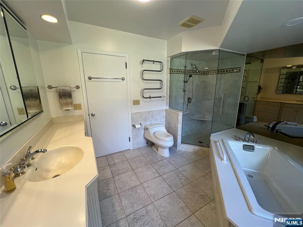 391 Forest Road Mahwah, NJ 07430 - Photo 14 of 32 a bathroom with a sink a toilet and shower