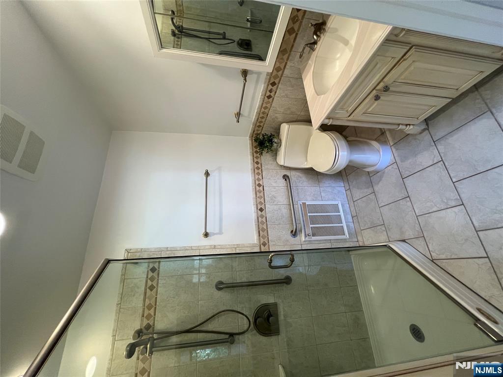 391 Forest Road Mahwah, NJ 07430 - Photo 21 of 32 a bathroom with a granite countertop sink toilet and shower