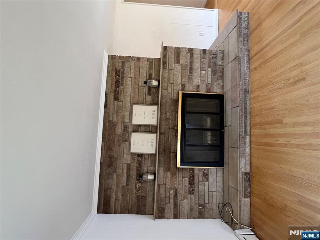 391 Forest Road Mahwah, NJ 07430 - Photo 6 of 32 a view of a fireplace with wooden floor