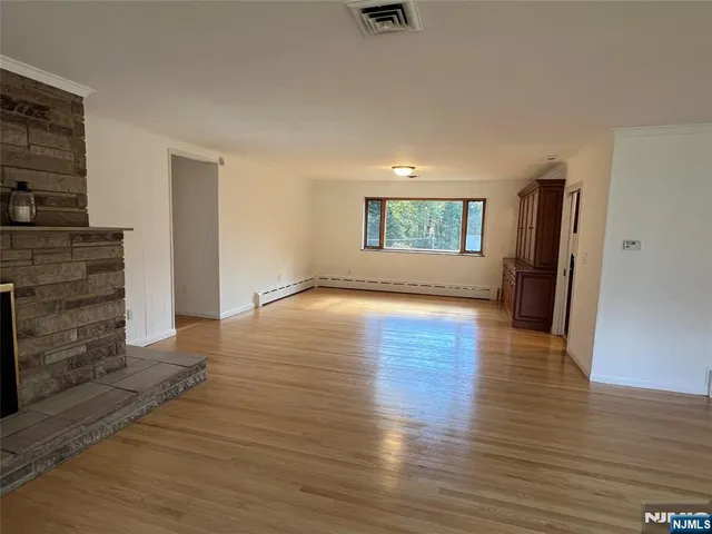 wooden floor in an empty room with a fireplace