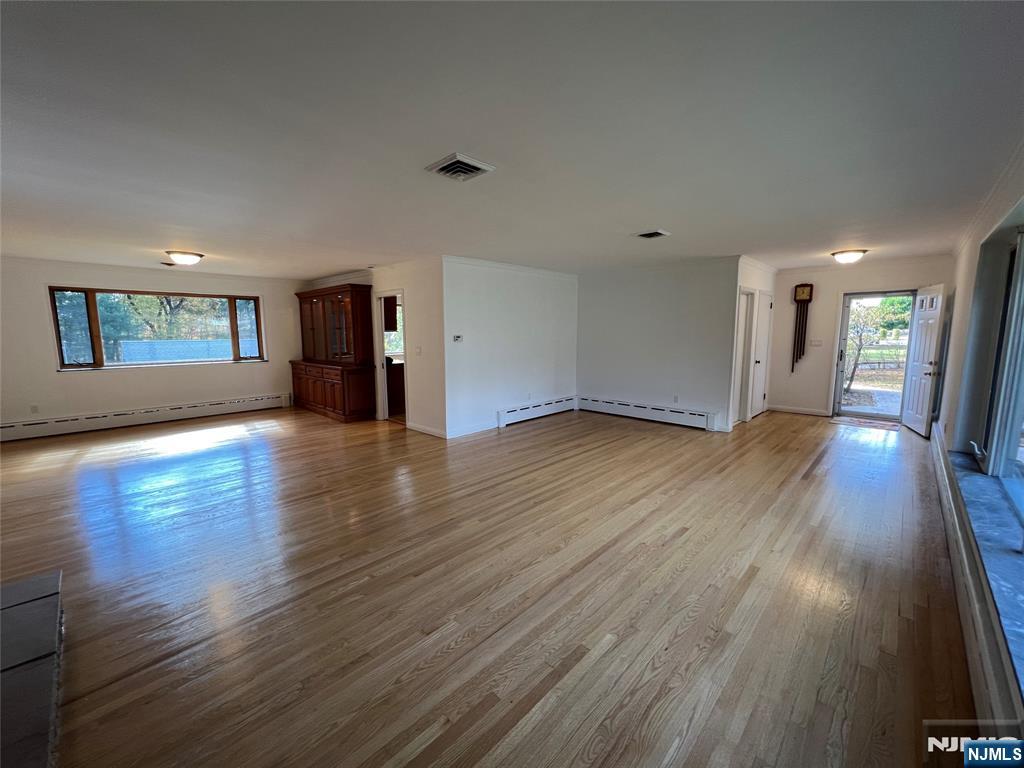 391 Forest Road Mahwah, NJ 07430 - Photo 8 of 32 an empty room with wooden floor and windows