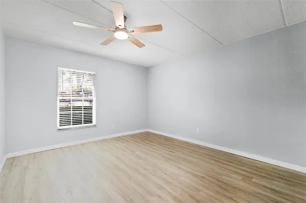 a view of an empty room with wooden floor