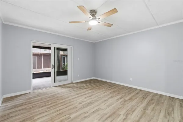a view of an empty room with wooden floor