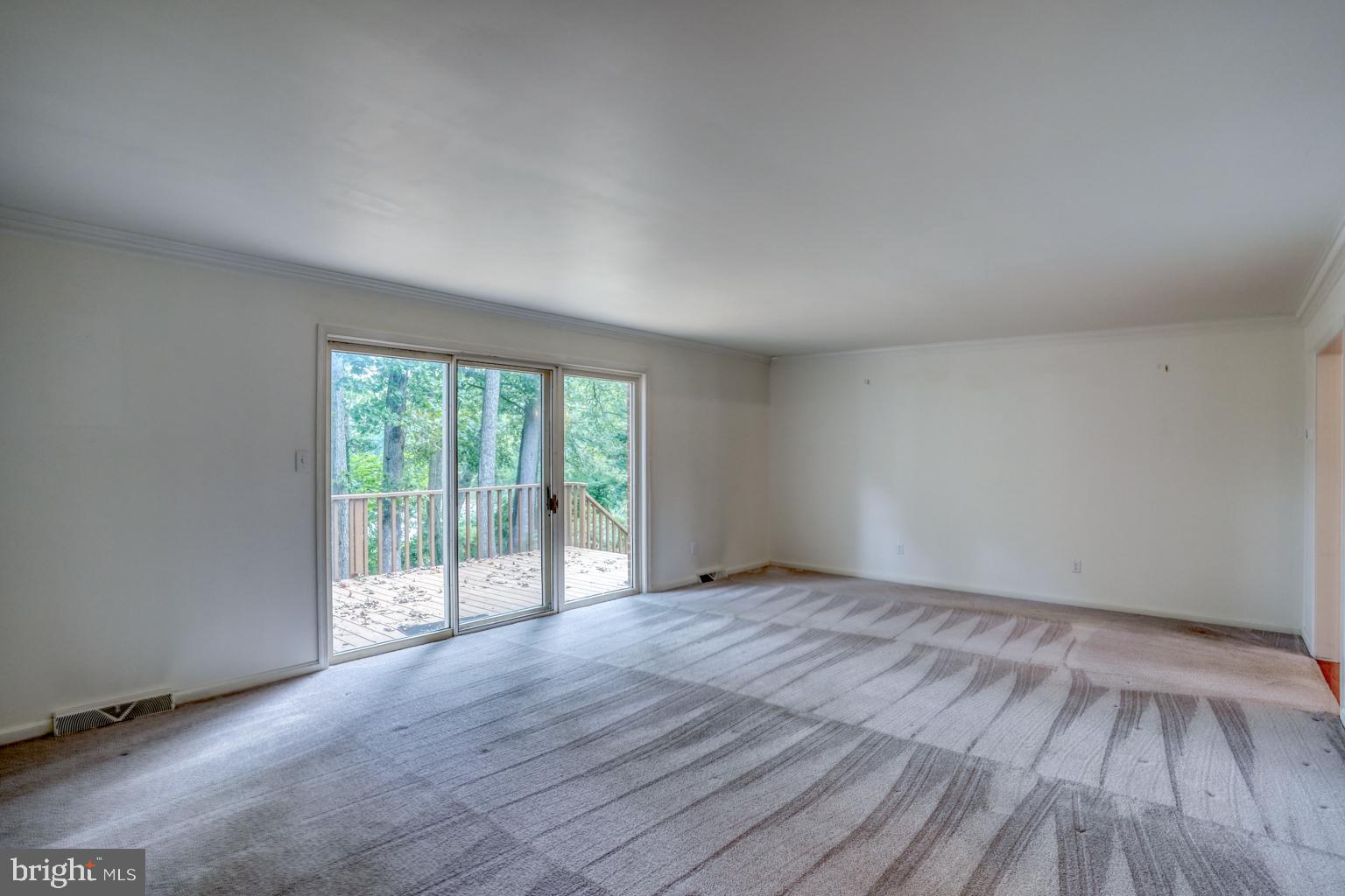 5 Stuart Drive Dover, DE 19901 - Photo 13 of 64 a view of an empty room with wooden floor and a window