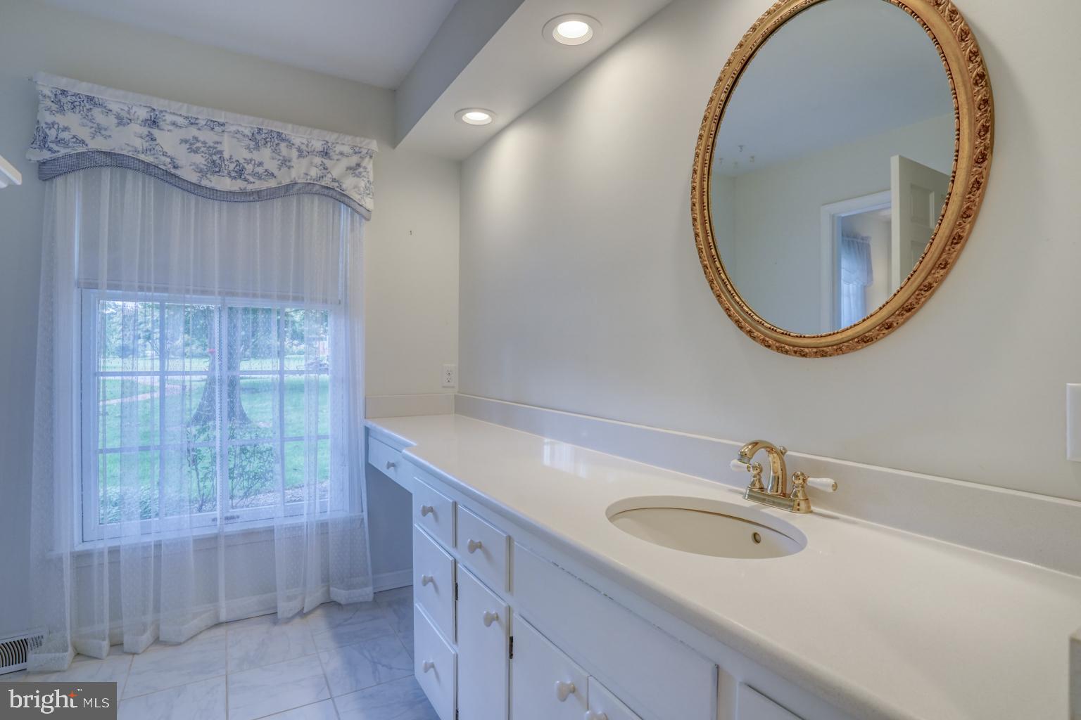 5 Stuart Drive Dover, DE 19901 - Photo 14 of 64 a bathroom with a sink and a mirror
