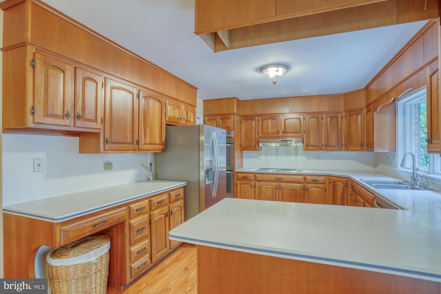 5 Stuart Drive Dover, DE 19901 - Photo 23 of 64 a kitchen with stainless steel appliances granite countertop a sink refrigerator and cabinets