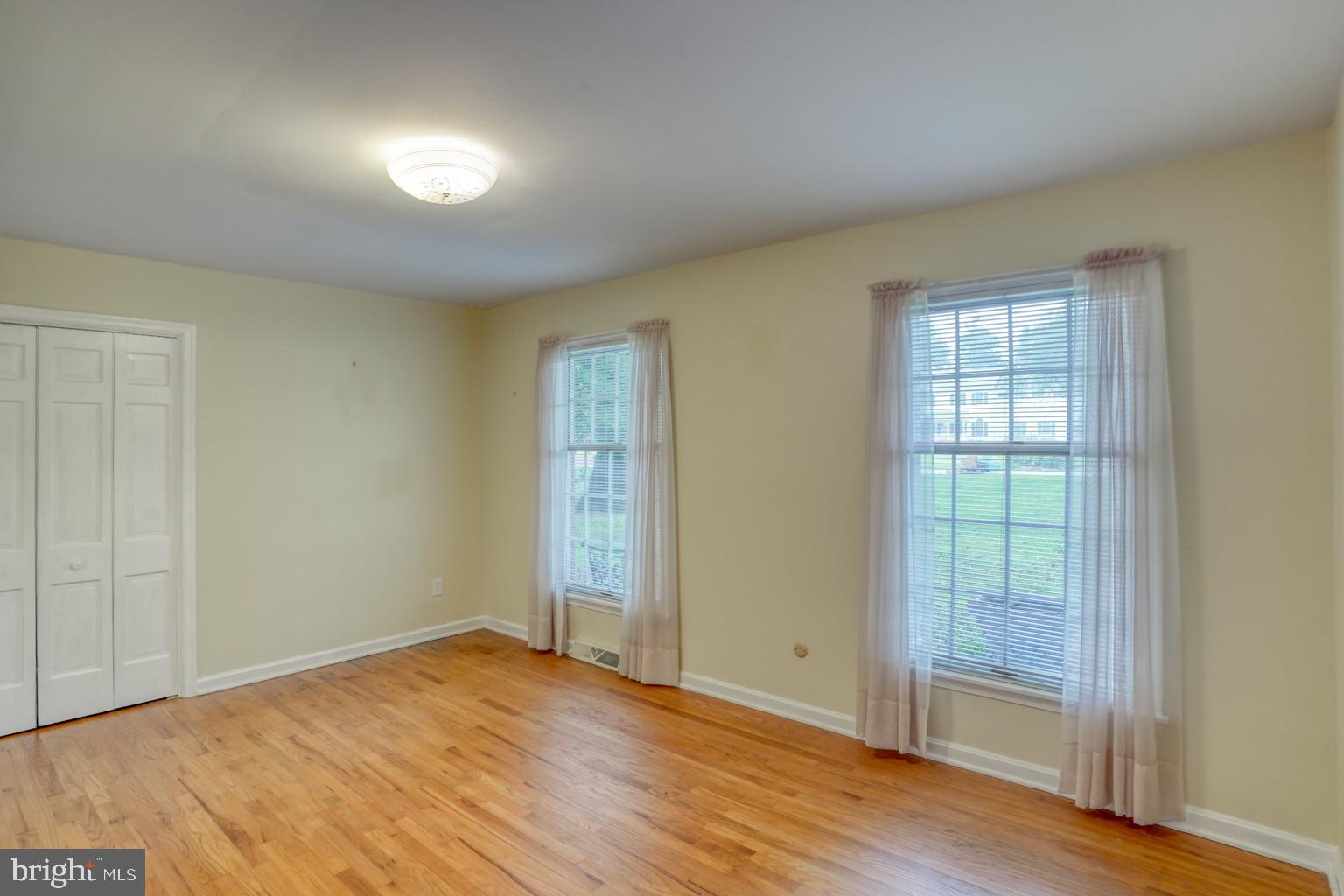 5 Stuart Drive Dover, DE 19901 - Photo 35 of 64 an empty room with wooden floor and windows