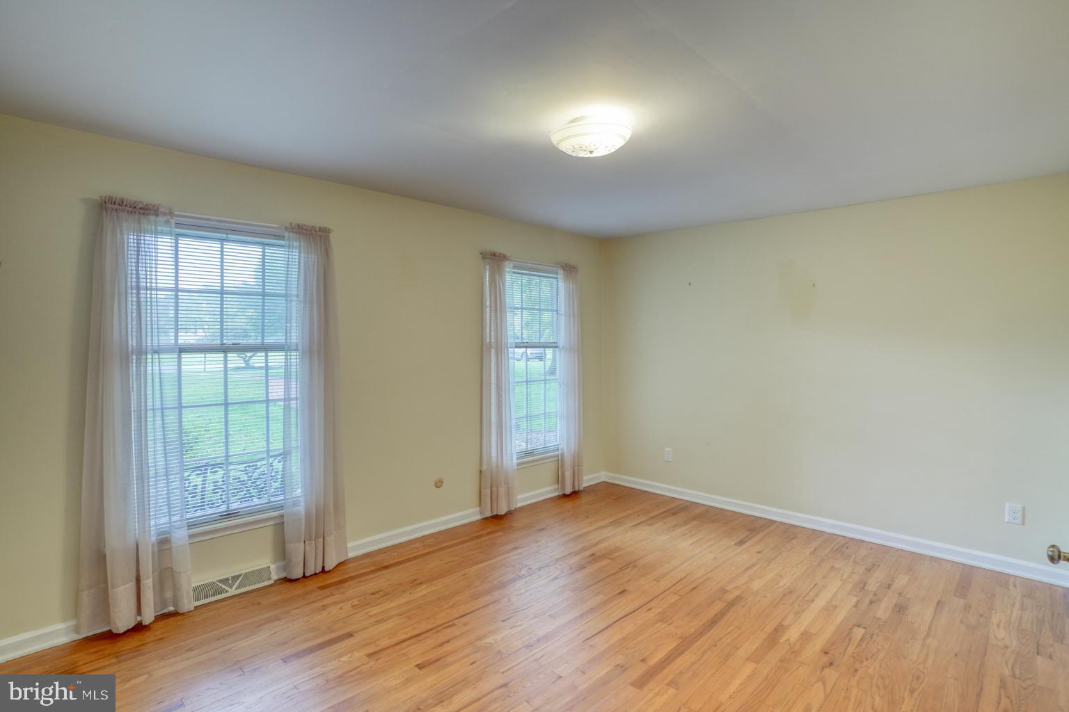 5 Stuart Drive Dover, DE 19901 - Photo 36 of 64 an empty room with wooden floor and windows