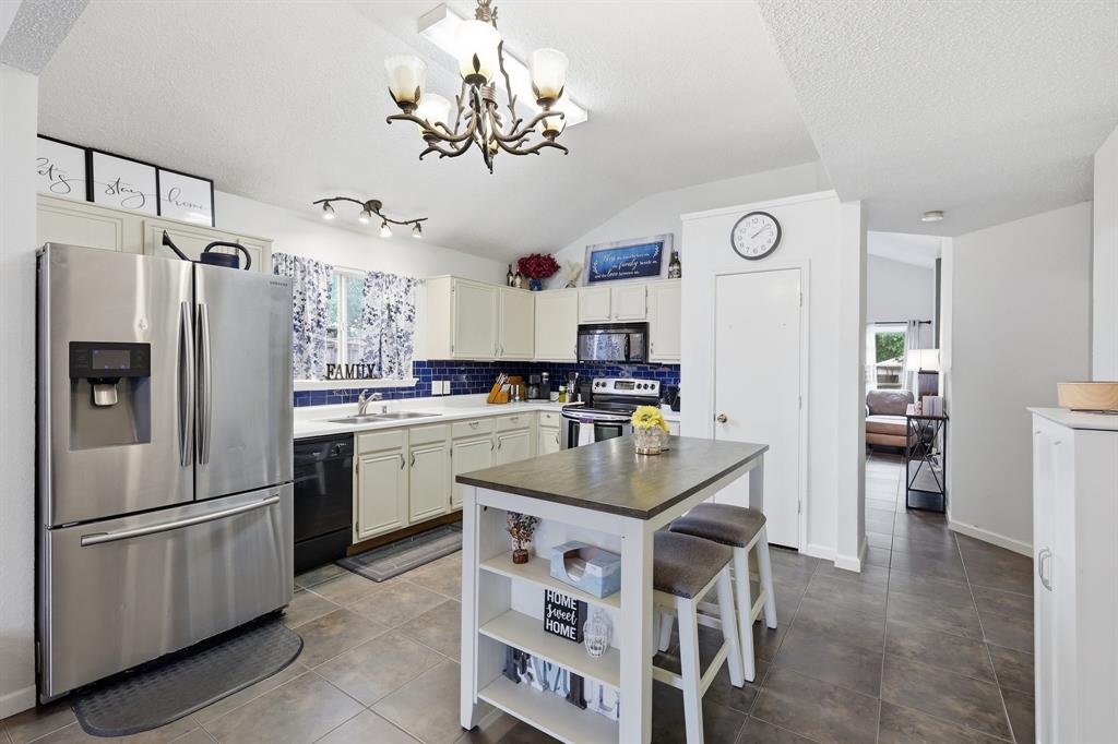 4217 Broken Arrow Road Fort Worth, TX 76137 - Photo 11 of 40 a kitchen with cabinets and stainless steel appliances