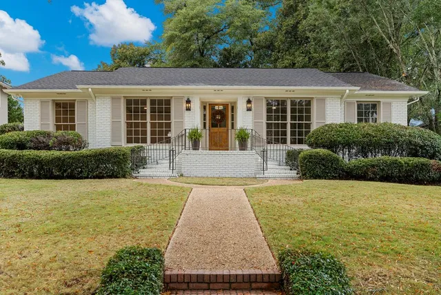 a front view of house with yard and outdoor seating