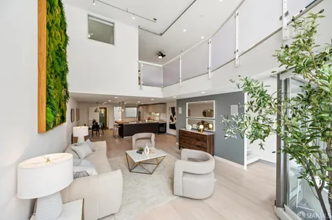 a living room with furniture and a potted plant