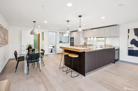 a kitchen with a sink cabinets and wooden floor