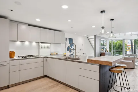 a kitchen with a sink window and cabinets