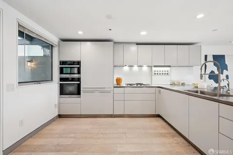 a kitchen with a sink cabinets and stainless steel appliances
