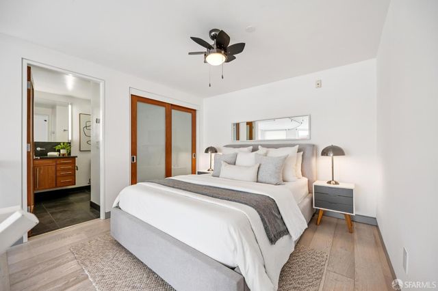 a bathroom with a granite countertop sink a toilet and a mirror