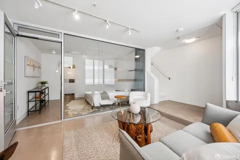 a bedroom with furniture and a wooden floor