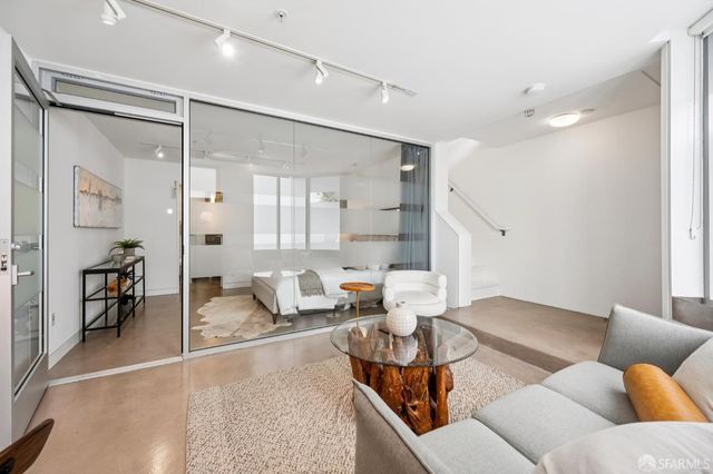 a bedroom with furniture and a wooden floor