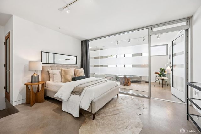 a bedroom with a bed and a large mirror