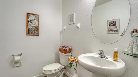 a bathroom with a toilet sink and mirror
