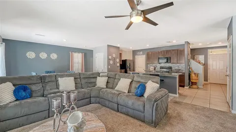 a living room with furniture and kitchen view