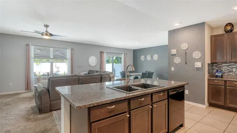 a kitchen with a stove a refrigerator and a sink