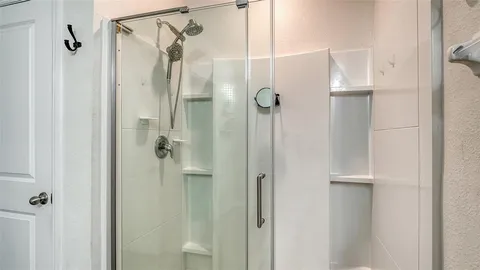 a bathroom with a glass shower door