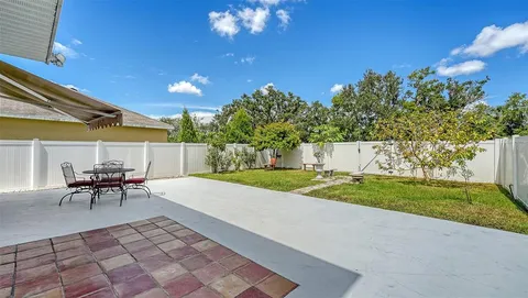 a view of a patio with table and chairs and potted plants