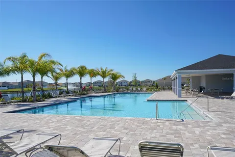 a view of a swimming pool with lounge chairs