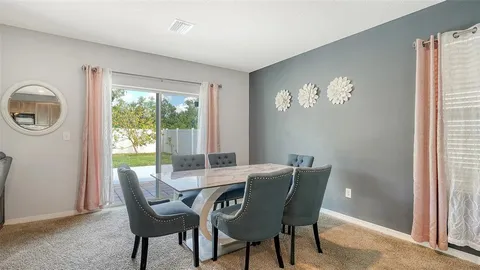 a view of a dining room with furniture window and outside view