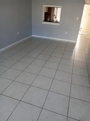 a view of a room with an empty space and window