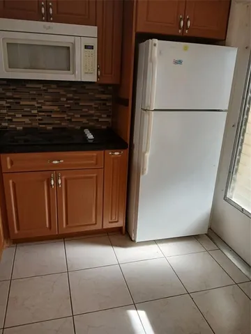a view of a refrigerator with washer and dryer