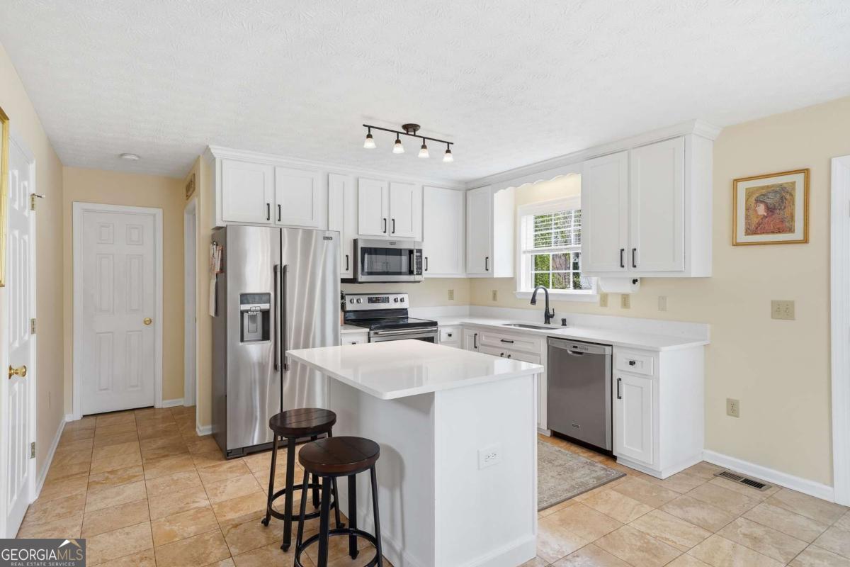 134 Nicholson Lane Talking Rock, GA 30175 - Photo 11 of 72 a kitchen with stainless steel appliances a sink stove refrigerator and cabinets