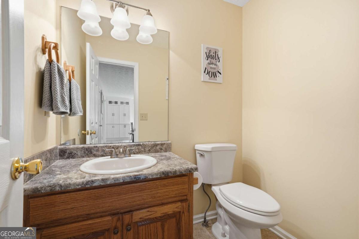 134 Nicholson Lane Talking Rock, GA 30175 - Photo 16 of 72 a bathroom with a granite countertop toilet sink and mirror