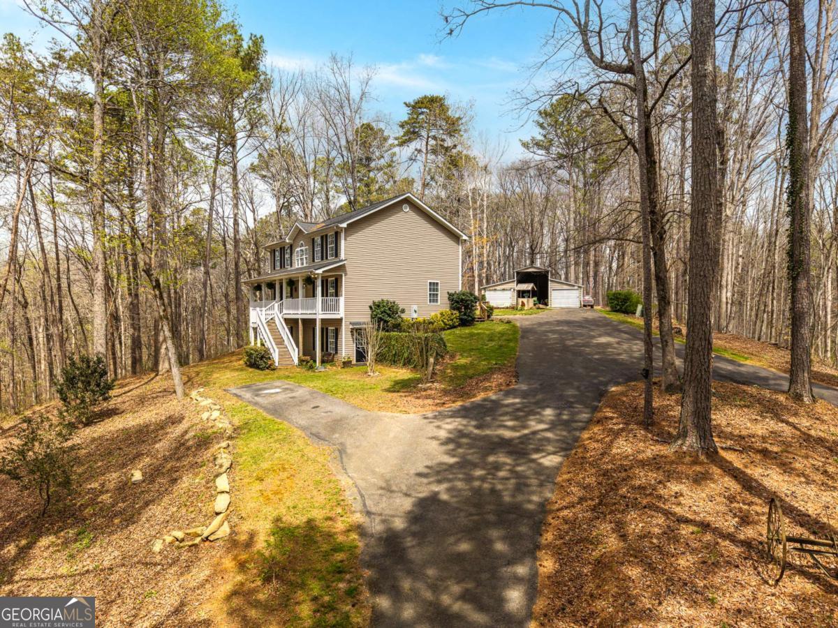 134 Nicholson Lane Talking Rock, GA 30175 - Photo 2 of 72 a view of a house with a yard covered in snow