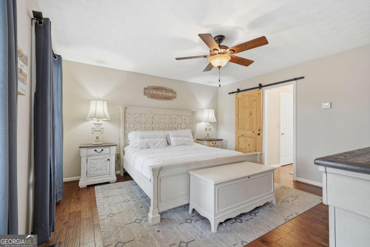 134 Nicholson Lane Talking Rock, GA 30175 - Photo 24 of 72 a bedroom with a bed and a chandelier