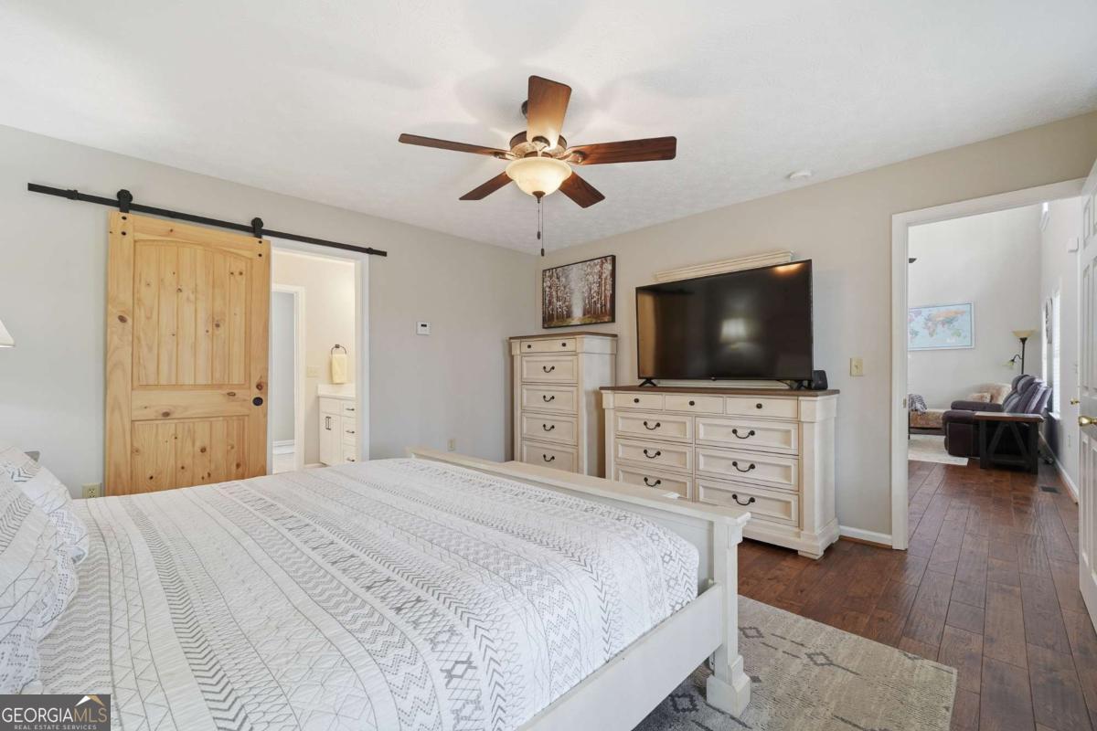134 Nicholson Lane Talking Rock, GA 30175 - Photo 25 of 72 a bedroom with a flat screen tv on dresser and a chandelier fan