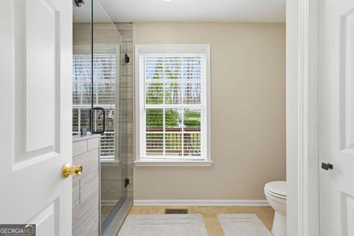 134 Nicholson Lane Talking Rock, GA 30175 - Photo 29 of 72 a bathroom with a toilet and a shower
