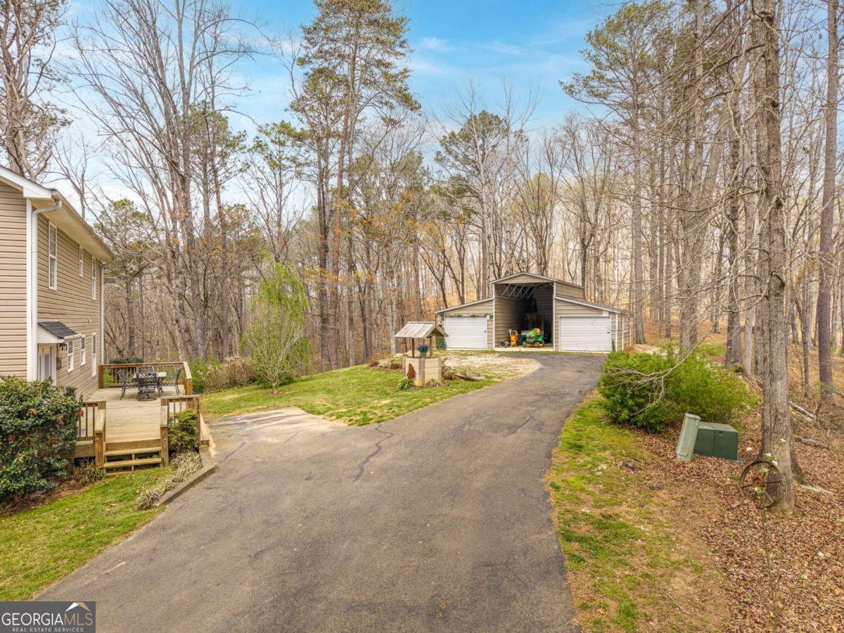 134 Nicholson Lane Talking Rock, GA 30175 - Photo 3 of 72 a front view of a house with garden and trees