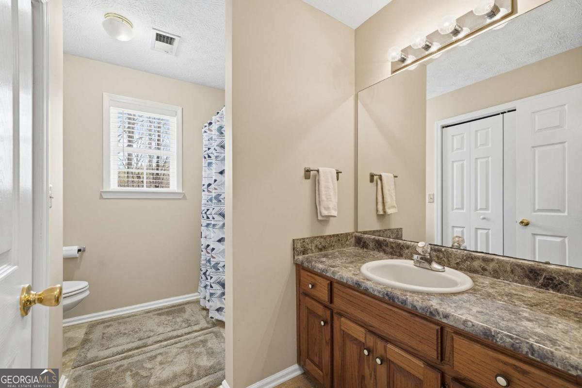 134 Nicholson Lane Talking Rock, GA 30175 - Photo 36 of 72 a bathroom with a granite countertop sink and a mirror