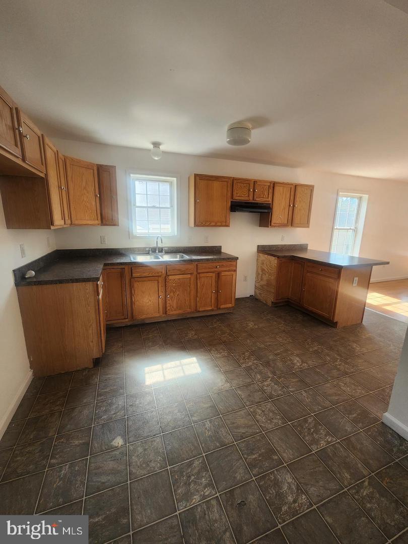 281 Spruce Street Bridgeton, NJ 08302 - Photo 13 of 18 a large kitchen with granite countertop a stove a sink dishwasher and a refrigerator