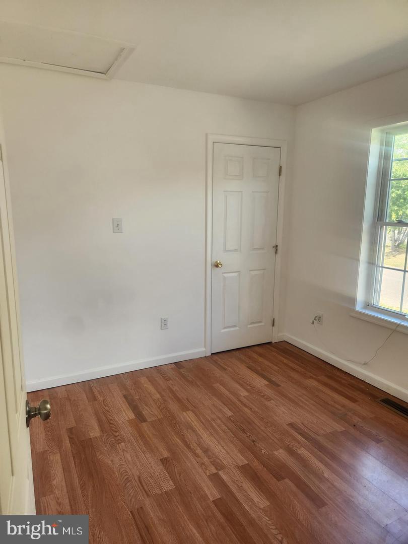 281 Spruce Street Bridgeton, NJ 08302 - Photo 14 of 18 a view of an empty room with wooden floor and a window