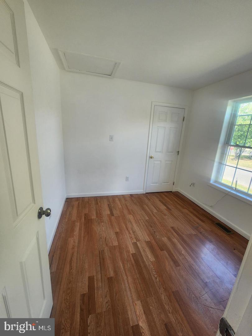 281 Spruce Street Bridgeton, NJ 08302 - Photo 17 of 18 a view of empty room with wooden floor and fan