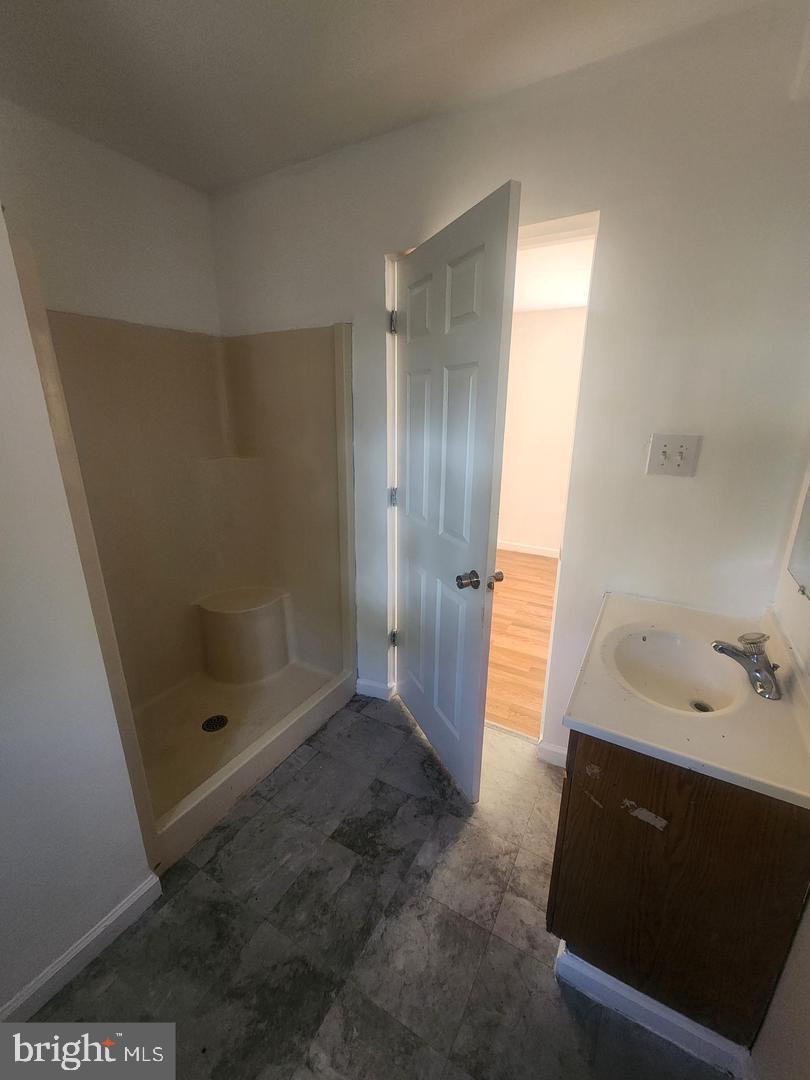 281 Spruce Street Bridgeton, NJ 08302 - Photo 4 of 18 a bathroom with a shower and a sink