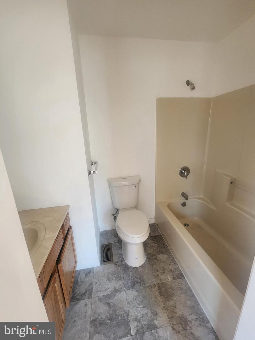 281 Spruce Street Bridgeton, NJ 08302 - Photo 9 of 18 a bathroom with a toilet a sink and bathtub